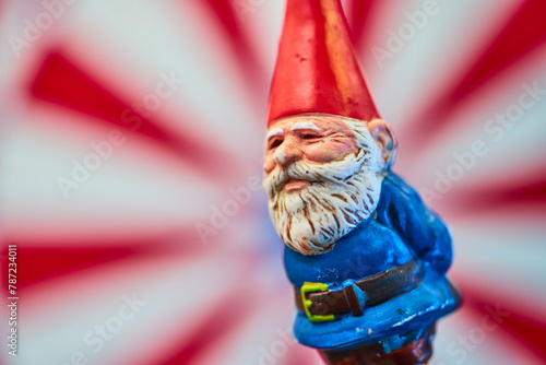 Whimsical Painted Garden Gnome Close-Up with Striped Background