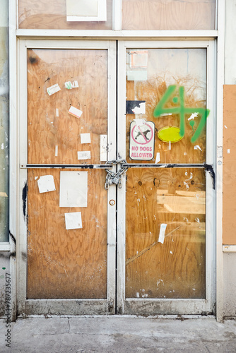 Chain and padlock on boarded up door photo