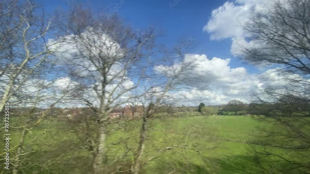 wide fields from train typical countryside in South England Kent sussex boarders Romney marsh area UK, flat blue sky - video footage wide fields from train typical countryside in South England Kent sussex boarders Romney marsh area UK, flat blue sky - video footage