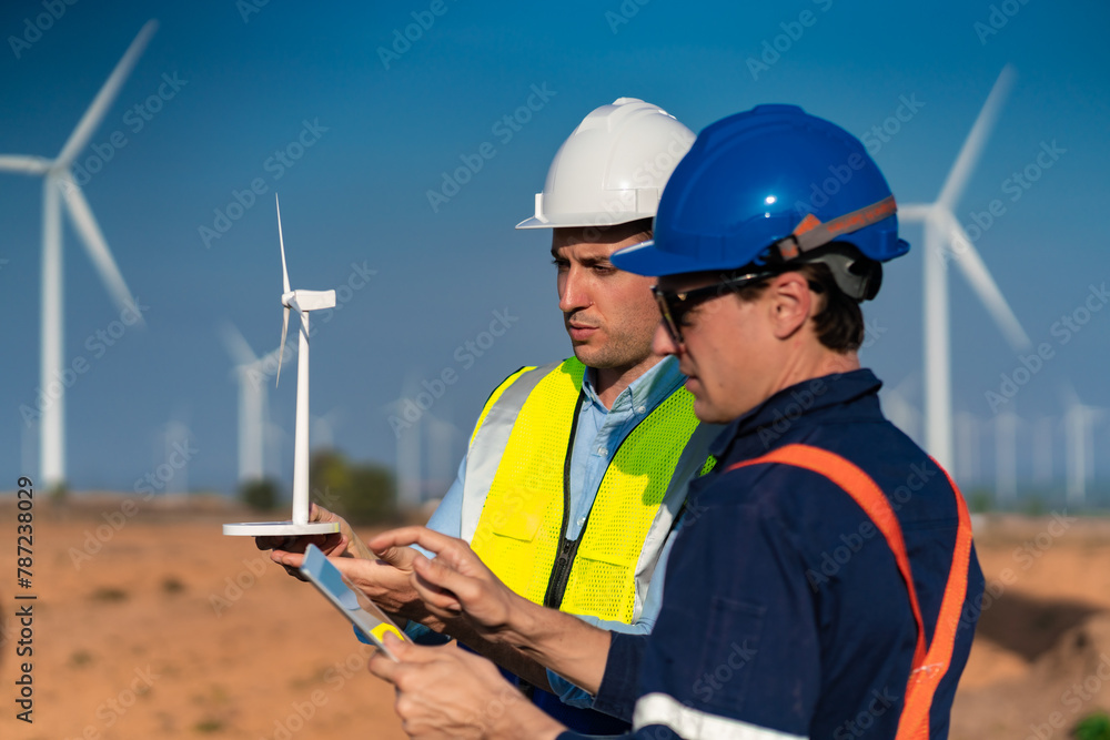 Green ecological power energy generation wind sustainable energy concept, Engineer wearing uniform hold equipment box inspection work in wind turbine farms to generate electricity energy industrial