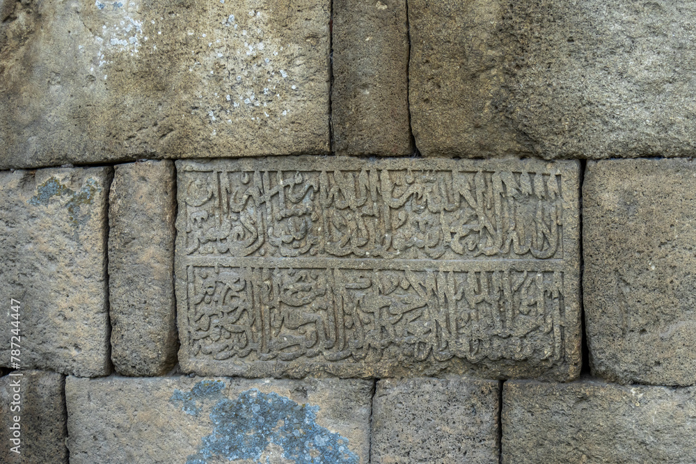 The entrance is at the fortress wall. It is a monument of ancient Persian fortification architecture, the wall is included in the UNESCO World Heritage List. An inscription carved in stone in Arabic.