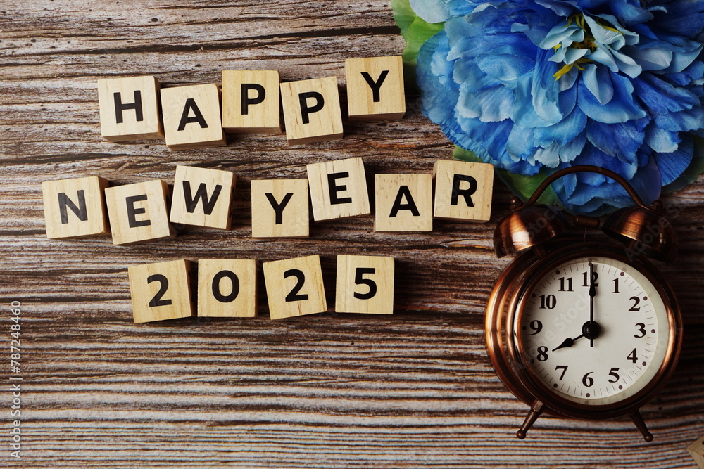 Happy New Year 2025 with alarm clock on wooden background Happy New Year 2025 with alarm clock on wooden background