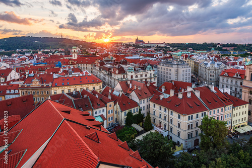 The aerial Prague cityscape of downtown and the castle and the St. Vitus Cathedral in sunset. 