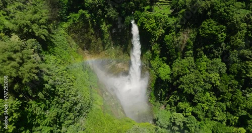 Beautiful Rainbow over Hikong Bente Waterfall surrounded by mountain jungle, rainforest and green trees. Lake Sebu. Mindanao, Philippines. photo