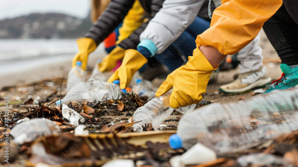 Obraz premium Inspiring photo of a diverse group of people working together, eco volunteers picking up plastic trash on the beach