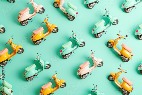 Colorful array of mopeds forming a pattern on green background with scooter and motorcycle written on them photo