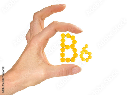 Vitamin B Pills isolated - B6 on white background with Woman Hand