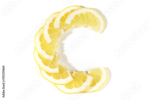 Vitamin C letter consists of pieces of lemon fruit on white background