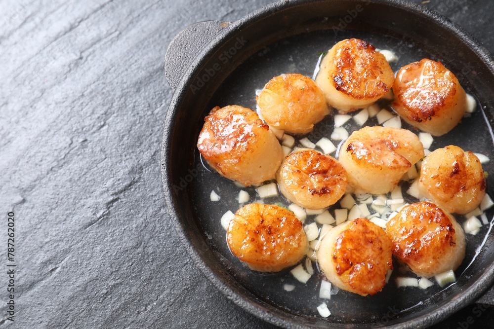 Delicious fried scallops on dark gray textured table, top view. Space for text Delicious fried scallops on dark gray textured table, top view. Space for text