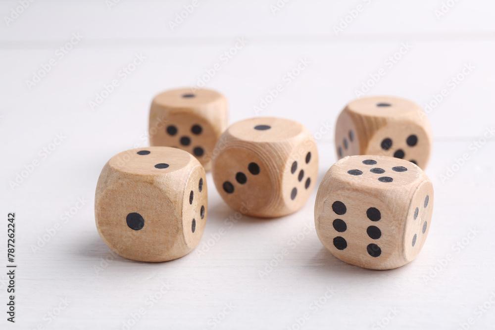 Many game dices on white wooden table, closeup Many game dices on white wooden table, closeup