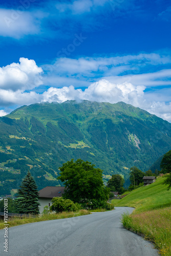 Road leading to the alpine scenery with clouds in the Austrian Alps (Schruns, Austria)