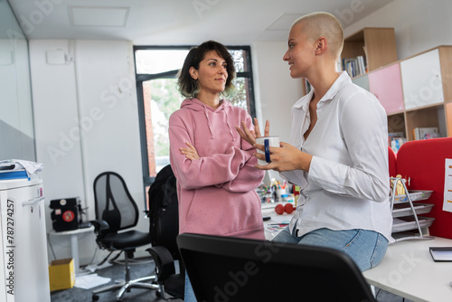 In student support office, a two female student joying in a coffee break, a beacon of empowerment and knowledge, ready to conquer academic challenges and embrace her future.