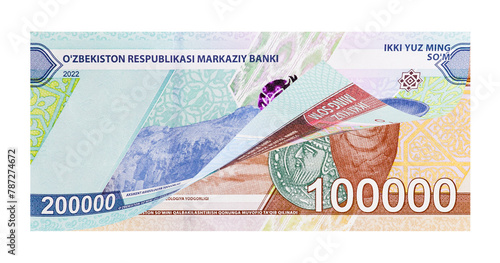 Uzbek two and one hundred-thousand banknotes as national money devaluation concept. Image isolated on white background