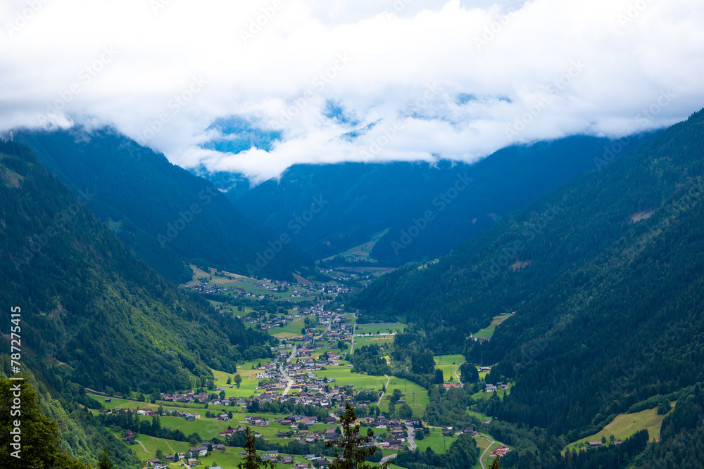 Fototapeta premium View of a Valley Basin with an Alpine Village in the Austrian Alps