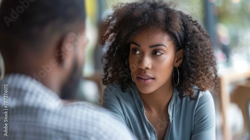 Closeup of two individuals having a calm and composed discussion maintaining eye contact and showing open body language a clear indication of emotional intelligence in managing conflict. . photo