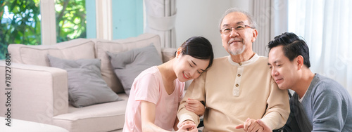 Photography Happy elder Asian man using wheelchair while exercise indoor house with his son