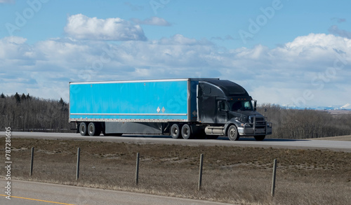 Heavy cargo on the road. A truck hauling freight along a highway. Taken in Canada