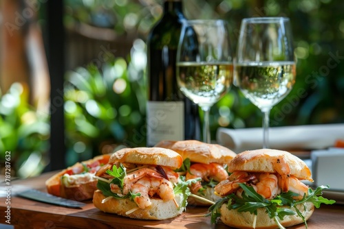 Exquisite prawn sandwiches paired with glasses of refreshing white wine on elegantly set table