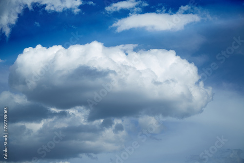 A large white cloud against a blue sky, cumulus clouds in the sky