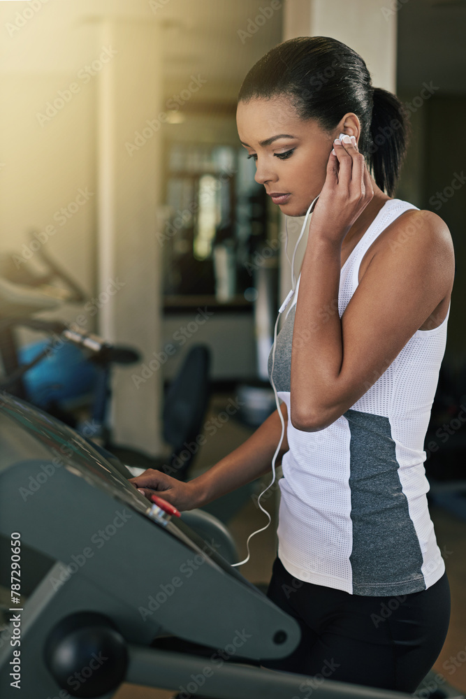 Black woman, gym and music in treadmill for workout to exercise and fitness routine for health. Female person, earphone and training or commitment for wellness, wellbeing and self care in sportswear Black woman, gym and music in treadmill for workout to exercise and fitness routine for health. Female person, earphone and training or commitment for wellness, wellbeing and self care in sportswear
