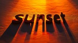 a close up of the word sunset on a yellow background