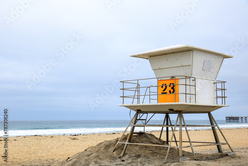 Elevated above sand lifeguard tower at empty Pacific Beach south of historic Crystal Pier in the early gloomy morning, San Diego, California © EuToch