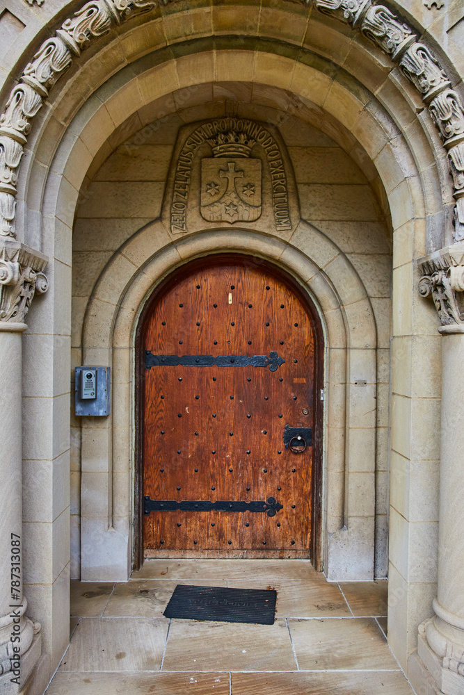 Historical Wooden Door with Heraldic Crest and Modern Intercom