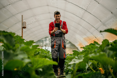 Portrait of a farmer checking his crops with a digital tablet