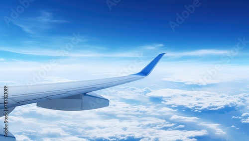 airplane wing in the sky with clouds