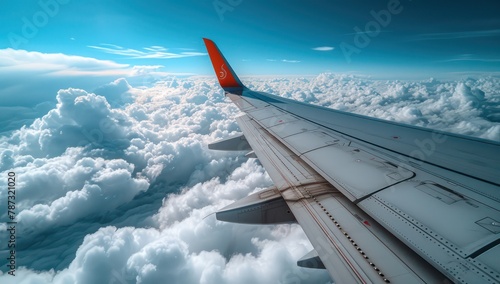 airplane wing in the sky with clouds