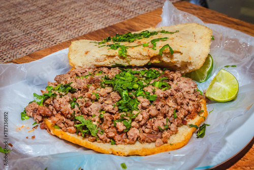 Gordita of beef with vegetables and sauce Mexican food dish photo