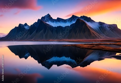 Vestrahorn mountaine on Stokksnes cape in Iceland during sunset with reflections. Amazing Iceland nature seascape. popular tourist attraction. Best famouse travel locations. photo
