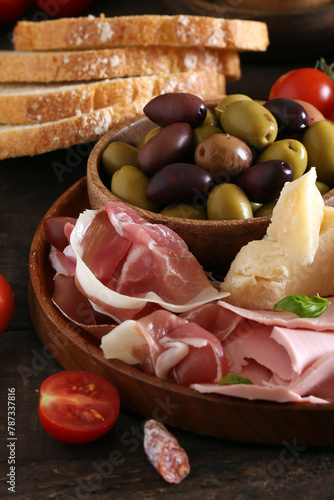 antipasti tapas with cheese and ham on wooden table