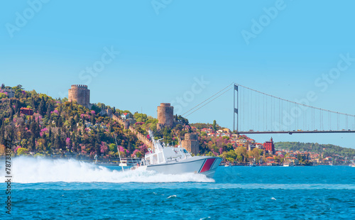 Rumeli Hisari (fortress) in to Bosphorus Sea - Coast Guard patrol boat rushing to the rescue - Istanbul, Turkey