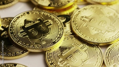 Golden bitcoin coins slowly spinning  photo