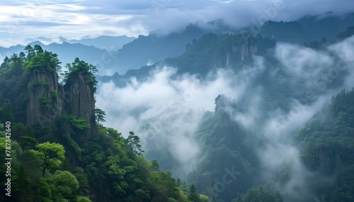 The magnificent and lush green mountain surrounded by clouds and mist  with unique rock formations above a beautiful and lush green valley