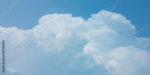 It's a hot day with the sun shining down on a blue sky filled with alternating small and huge clouds moving gently while the light from the sky creates a remarkable abstract shape. Horizon, Cloud Back