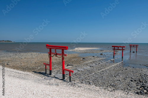 View of red torii gates at Oouo Shrine by sea, Tara, Saga © Blanscape