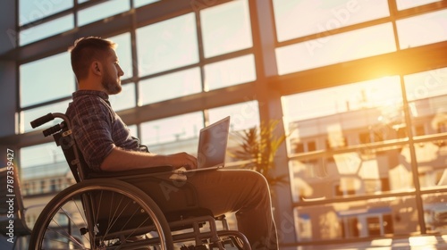 Man in wheelchair using laptop photo
