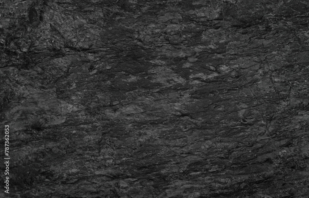 Empty black rough stone wall for abstract  background and texture. beautiful patterns, space for work, banner,seamless wallpaper, close up.