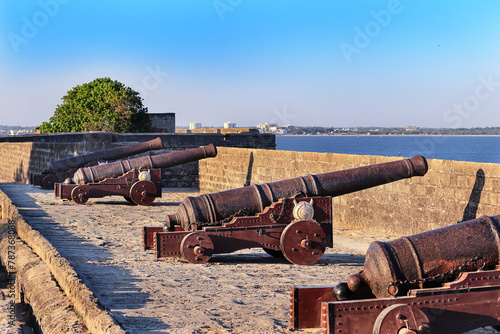 This famous tourist landmarks overlooks the sea. movable sixteenth century Portuguese cannon made of metal and a wooden base. It's located on a bastion of Diu Fort, a tourist spot located in Diu India photo