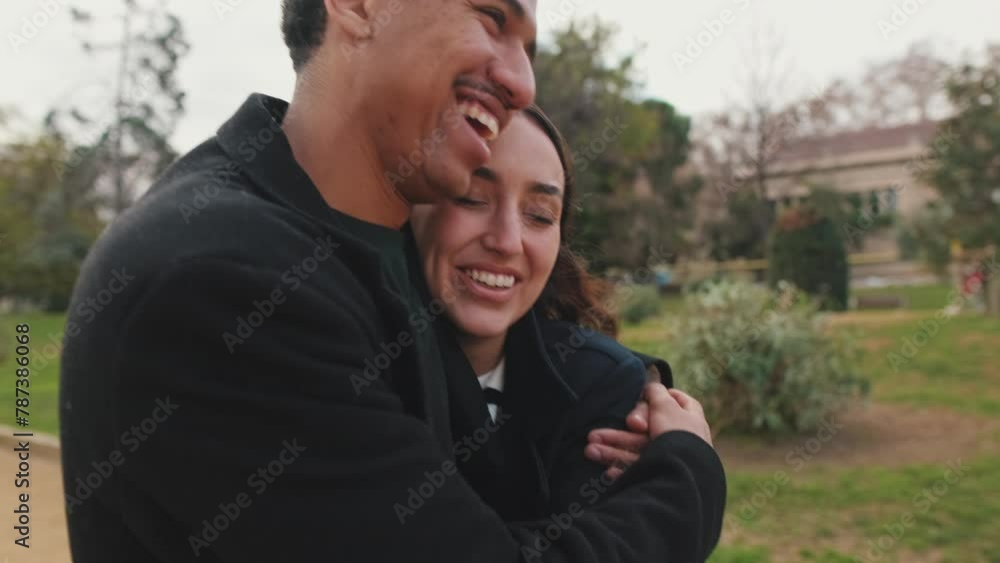Young couple embracing in park. Young couple embracing in park.