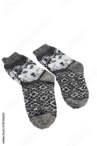 Detail of some thick wool gray socks with a drawing of a wolf on a white background.