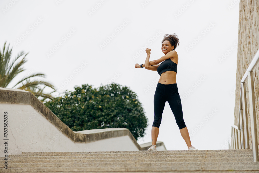 Sporty woman does warm-up exercises in morning before running training outside. Healthy fitness Sporty woman does warm-up exercises in morning before running training outside. Healthy fitness