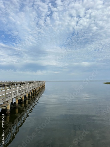 Pier with reflections over the Choctawhatchee Bay Florida 