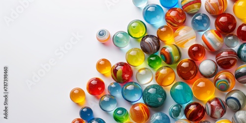 An array of multicolored glass marbles scattered on a white surface, showcasing a variety of patterns and translucency photo