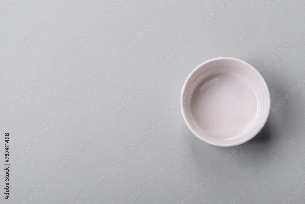 An empty plate on a gray concrete background with copy space An empty plate on a gray concrete background with copy space