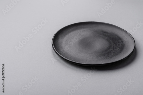 An empty plate on a gray concrete background with copy space