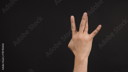 Hip-hop west coast hand sign on black background.