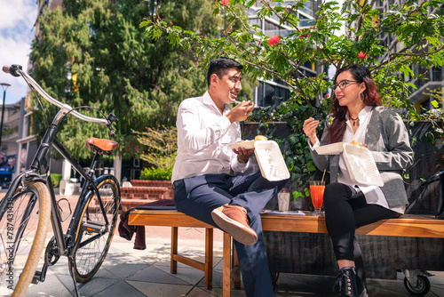 Friends go to lunch to a public square full of vegetation around. photo